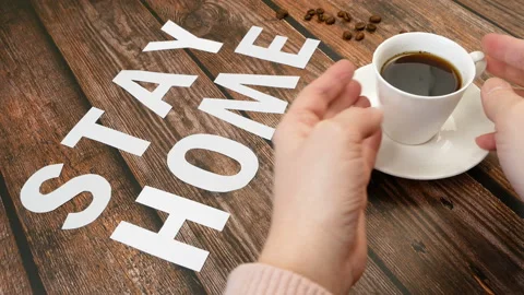 Mug of coffee, coffee beans, and words stay home, coronavirus concept, self h Video stock 128758423