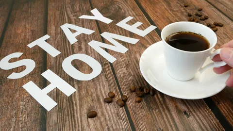 Mug of coffee, coffee beans, and words stay home, coronavirus concept, self h Video stock 128758865