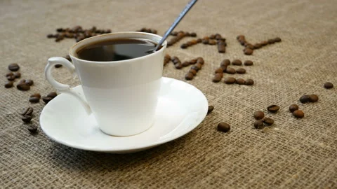 Mug of coffee, coffee beans, and words stay home, coronavirus concept, self h Video stock 129387683