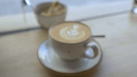 A mug of coffee is on the table in a cafe. The camera moves forward. Video stock 94917138
