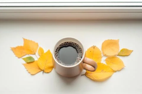 Mug with coffee on the windowsill Stock Photos