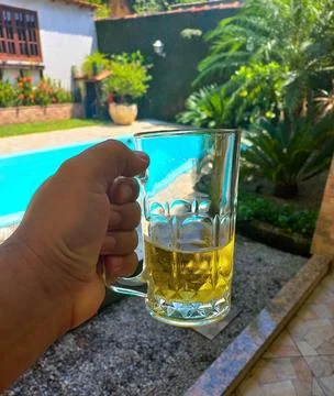 Mug of cold beer by the pool Stock Photos