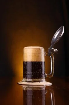 Mug of dark beer Stock Photos