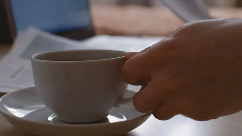 Mug with drink in the foreground. Stockbeeldmateriaal 104084896