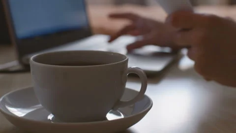 Mug with drink in the foreground. Stockbeeldmateriaal 104085013