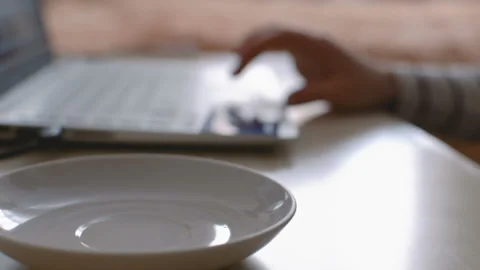 Mug with drink in the foreground. Stockbeeldmateriaal 104085031