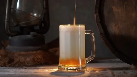 Mug with fresh light beer with foam on wooden vintage background with barrel Stock Footage 167055282