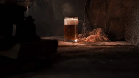 Mug with fresh light beer with foam on wooden vintage background with barrel Stock Footage 167055377