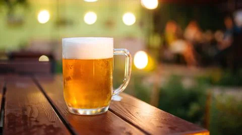 Mug of fresh light beer on the table Stock Photos