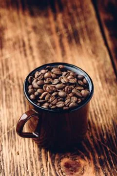 Mug full of roasted coffee beans Stock Photos