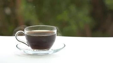 Mug of hot coffee or tea on the table Stockbeeldmateriaal 85664024