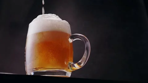 Mug of light beer with trendy low angle of view on black background Stock Footage 135699310
