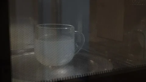 Mug rotates in a microwave oven Stock Footage 342864230