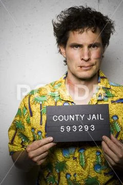 Mug shot of man in Hawaiian shirt with cuts and scrapes Stock Photos