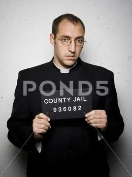 Mug Shot Of Priest With Glasses
