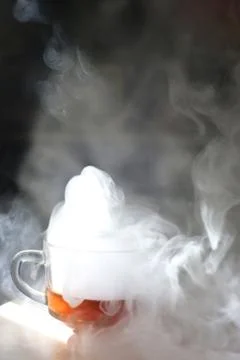 Mug with smoke on a table Stock Photos