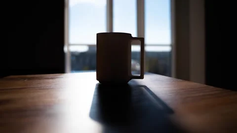The mug is on the table against the background of the window Stock Footage 255401512