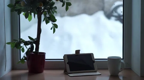 A mug of tea and a computer winter window Stock Footage 59186203