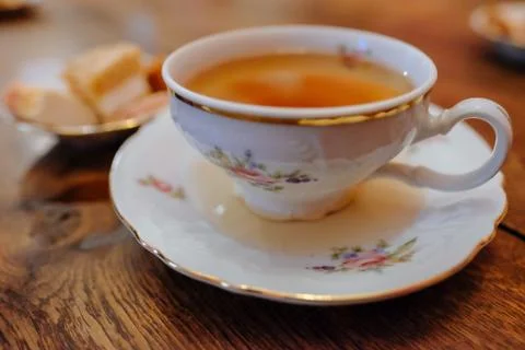Mug with tea and sweets on the table Stock Photos