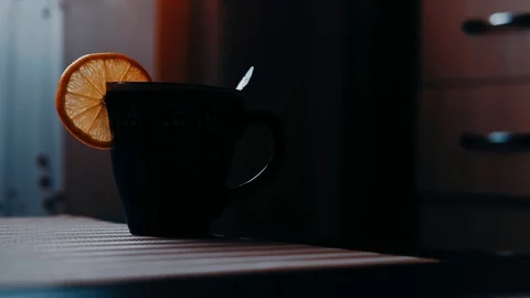 Mug of tea with lemon on the table Stock Footage 121993893