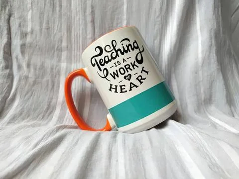 Mug with teaching is a work of heart quote on a gray background Stock Photos