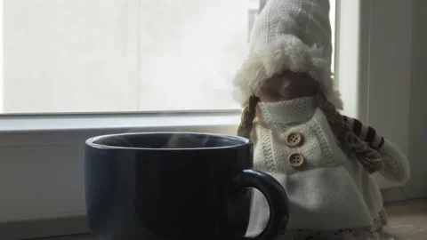 A mug of winter tea on the windowsill Stock Footage 202139096