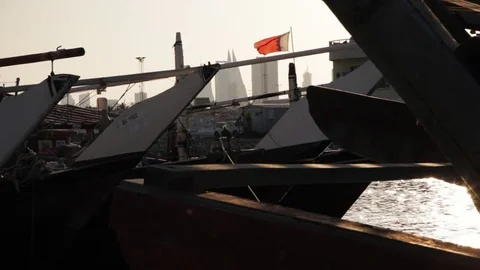 Muharraq Port. Dhows at sunset. Pan until Sun Flare. Bahrain Stock Footage 73686040