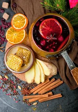 Mulled wine, blue pine tree branch and spices on wooden background Stock Photos