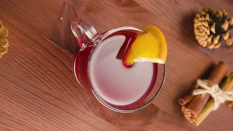 Mulled wine glass with orange slice. Christmas mulled wine and ingredients Stock Footage 225339717