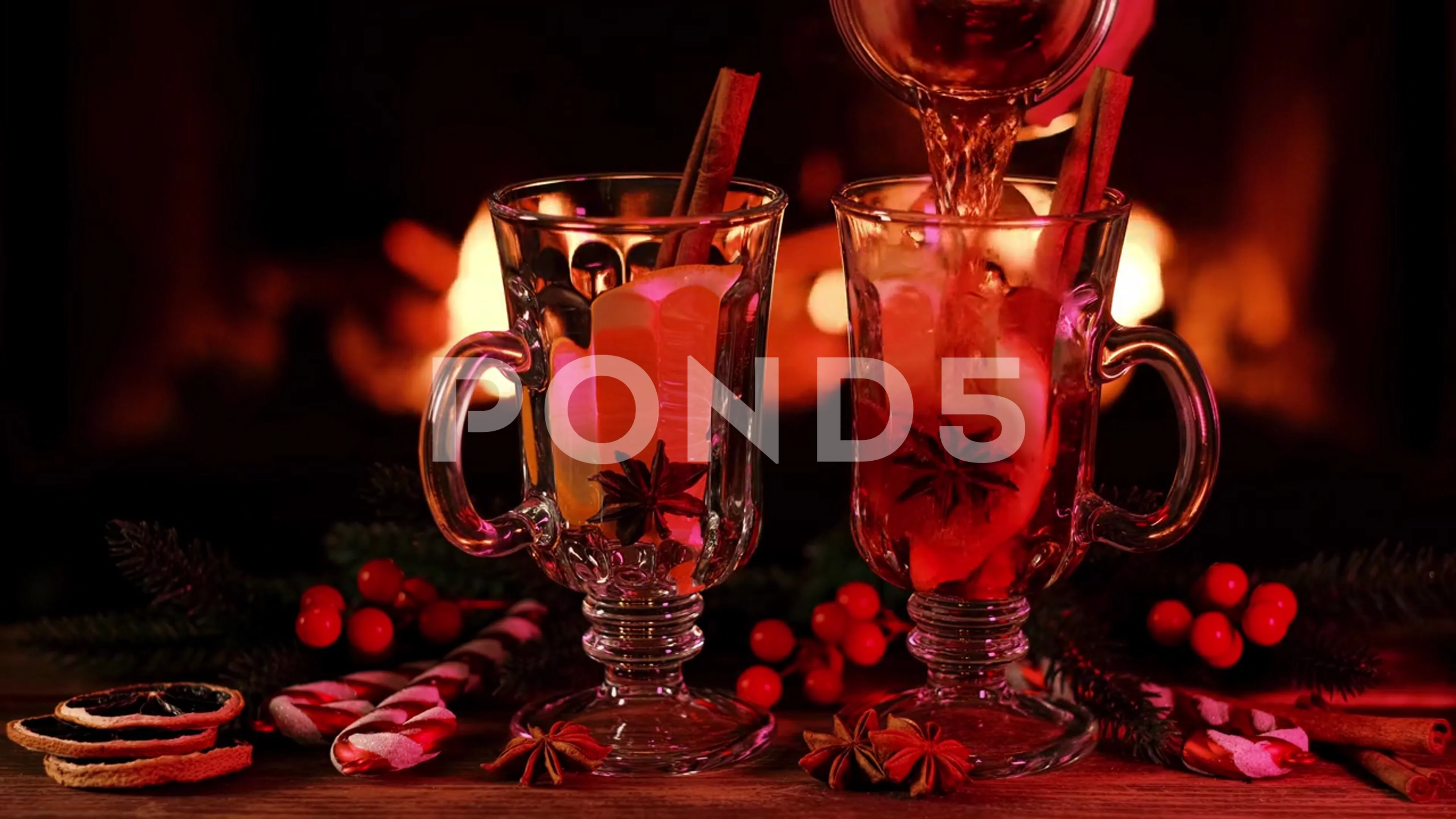 Two mulled wine glasses by the fireplace, christmas time Stock