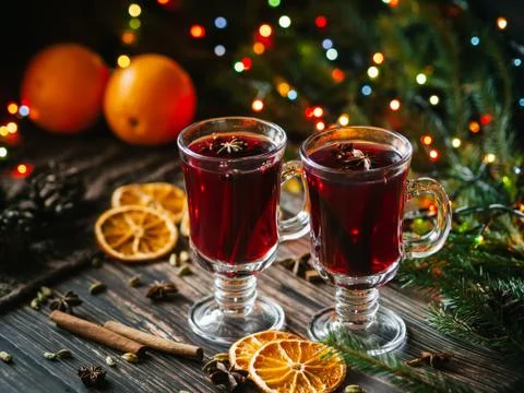Mulled wine in glasses on the table decorated with a Christmas tree. Orange Stock Photos