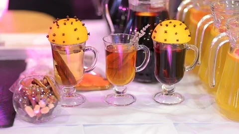 Mulled wine, hot tea with cinnamon and orange juice on table Stock Footage 99701683