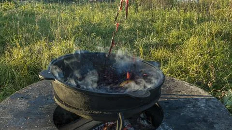 Mulled wine in a large cauldron. Mulled wine is cooked in a large pot. Vitami Stock Photos
