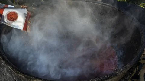 Mulled wine in a large cauldron. Mulled wine is cooked in a large pot. Vitami Stock Photos