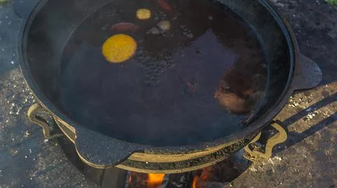 Mulled wine in a large cauldron. Mulled wine is cooked in a large pot. Vitami Stock Photos