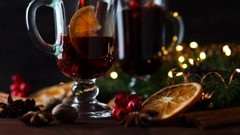 Mulled wine is poured into mugs on the table among Christmas decorations, slow 库存影片 100407422