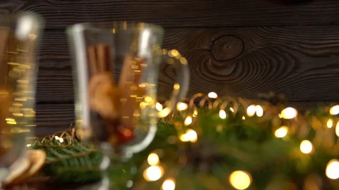Mulled wine is poured into mugs on the table among Christmas decorations, slow Stock Footage 100407424