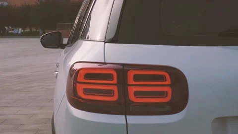 Multi-angle video of a white city SUV parked in the square Stock Footage 156942984