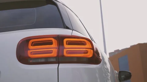 Multi-angle video of a white city SUV parked in the square Stock Footage 156943013