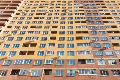 Multi-apartment multi-storey brick modern house facade, bottom view Stock Photos