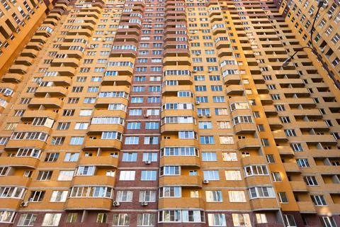 Multi-apartment multi-storey brick modern house facade, bottom view Stock Photos