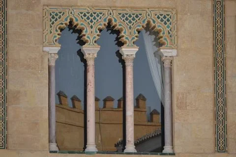 A multi-arched window in **Moorish style** features intricate **teal and gold Stock Photos