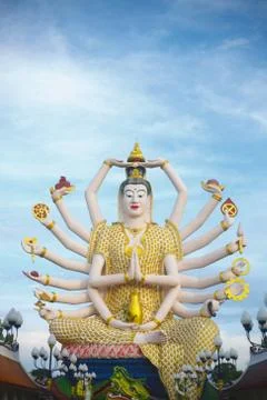 Multi-armed Buddhist deity against the blue sky Stock Photos