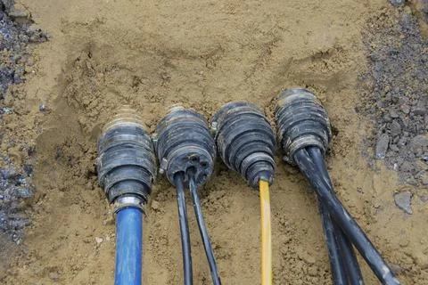 Multi-branch house connection with drinking water pipe, fibre optic cable and Stock Photos