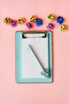 Multi color bows for gift box wrapping and blue color clipboard with silver trim Stock Photos