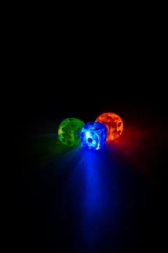 Multi color dice shinning in the dark by soft light Stock Photos