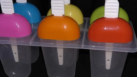 Multi color ice cream popsicle makers rotating and circling Stock Footage 111274872