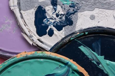 Multi color old paint can lids Stock Photos