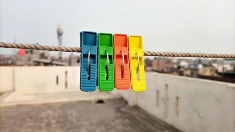 Multi color plastic clothes pins or clothes pegs for house hanging on rope  Stock Footage 306339887