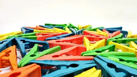 Multi color plastic laundry clips rotating on the white background, Clothes.. Stock Footage 305894482